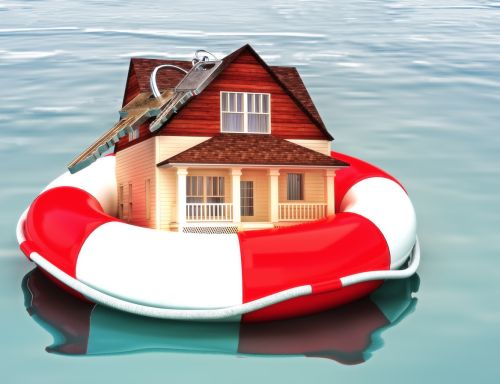 Home and keys floating on a life preserver, visual concept for legal blog discussing signing a reaffirmation agreement after chapter 7 bankruptcy.