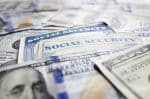 Social Security cards and assorted cash Concept for social security and divorce.