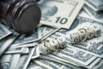 Shot of word divorce wrapped in wedding rings on a pile of money concept for blog: Divorce Planning: 7 Ways You Can Financially Prepare For A Divorce