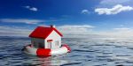 Life buoy and a small house on blue sea and sky background. Concept of how to keep your home during bankruptcy
