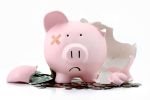 Broken sad pink piggy bank concept for tips for filing bankruptcy.
